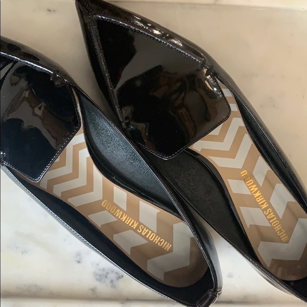 Nicholas Kirkwood black gold trimmed heel flats.
